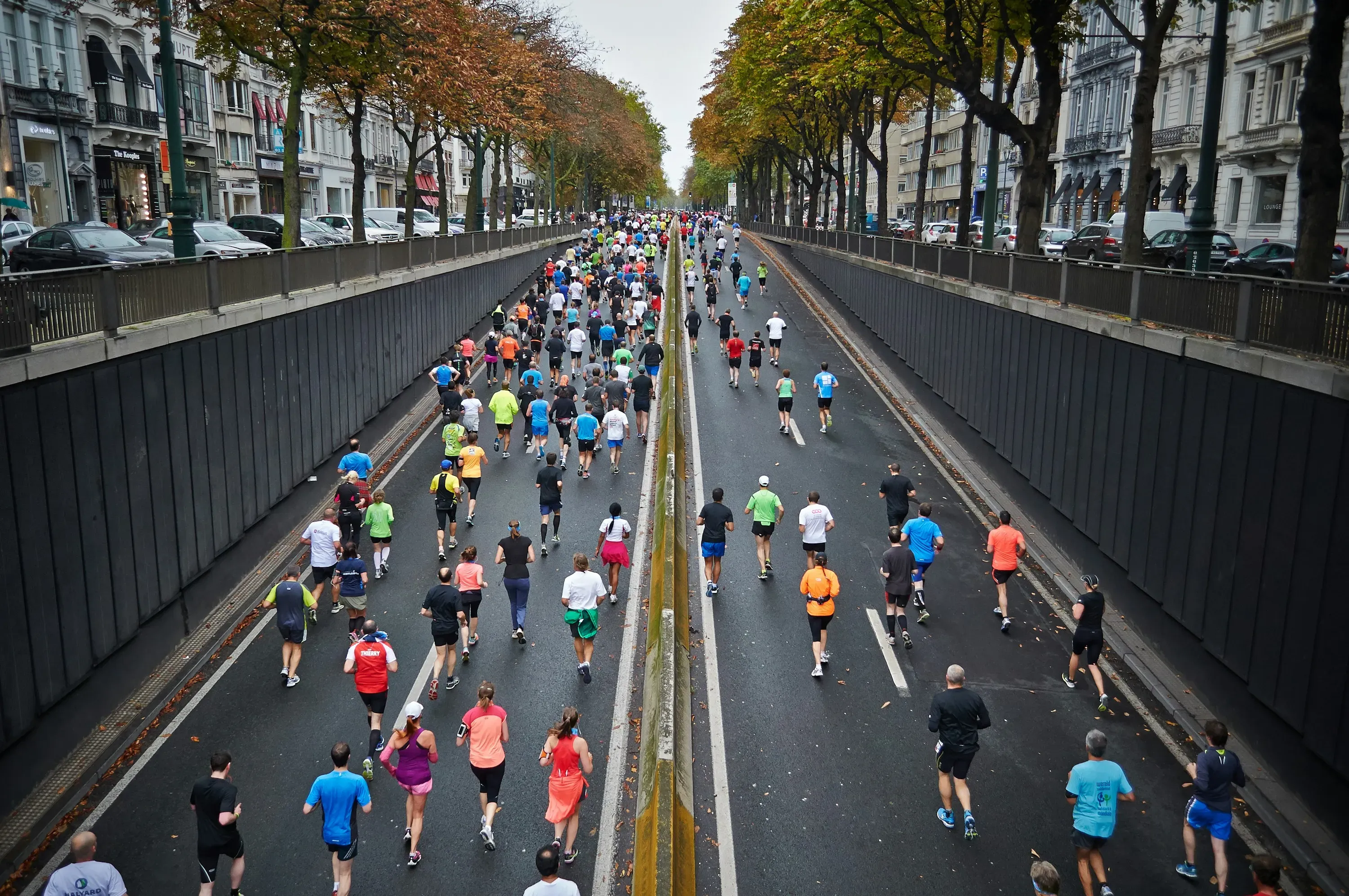 Runners participating in marathon race through city streets.
